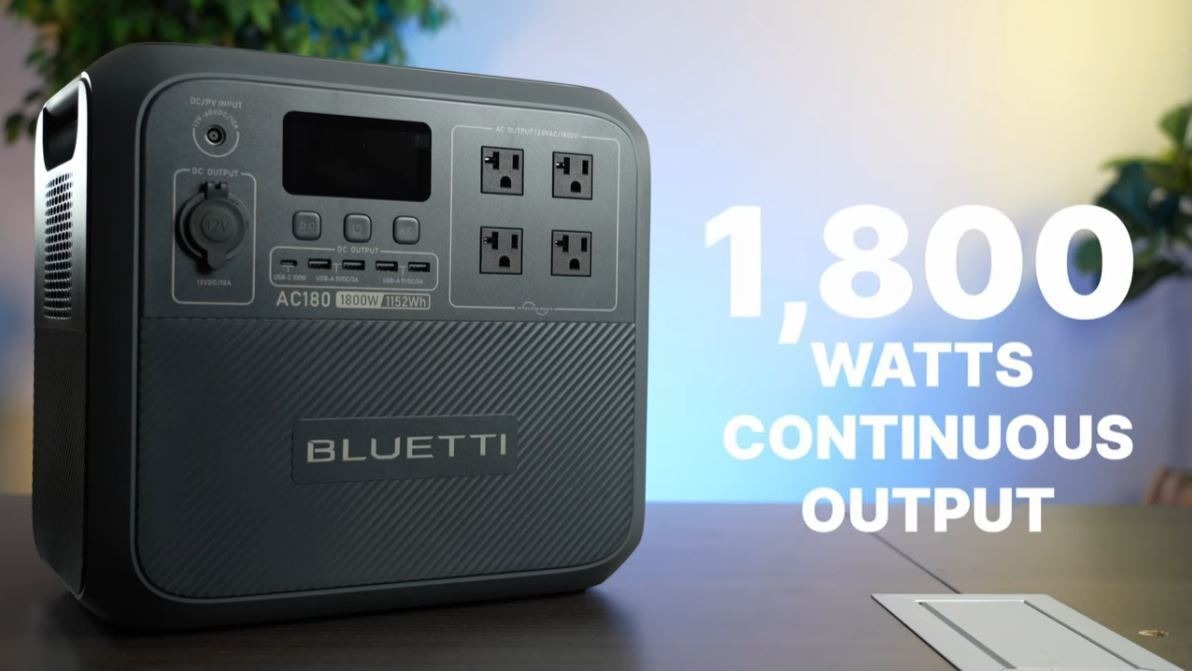 A photo of the Bluetti AC180 on a table with the words "1,800 watts continuous output" overlaid next to it