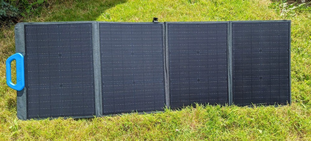 A photo of Bluetti PV120 solar panel unfolded on a sunny lawn