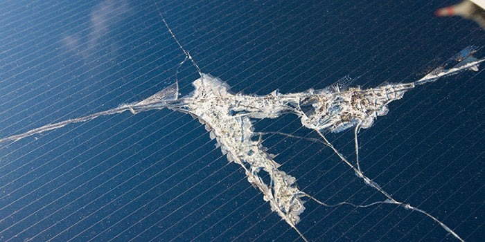 close-up of solar panel with crack in it