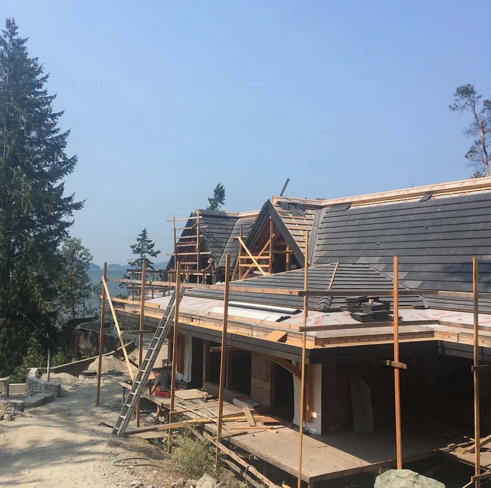 Ergosun charcoal tile being installed on a roof