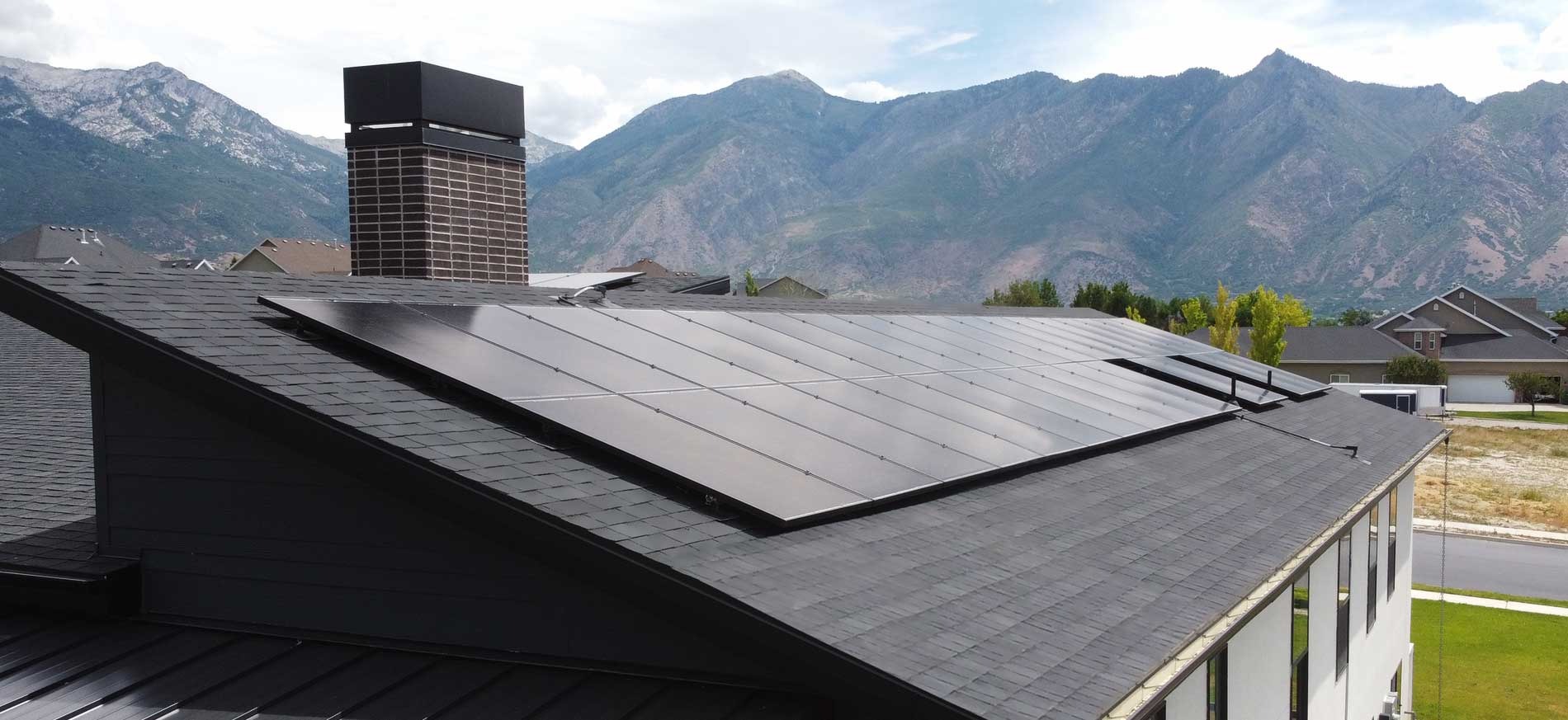 Silfab solar panels on a residential roof with a scenic view of mountains in the background