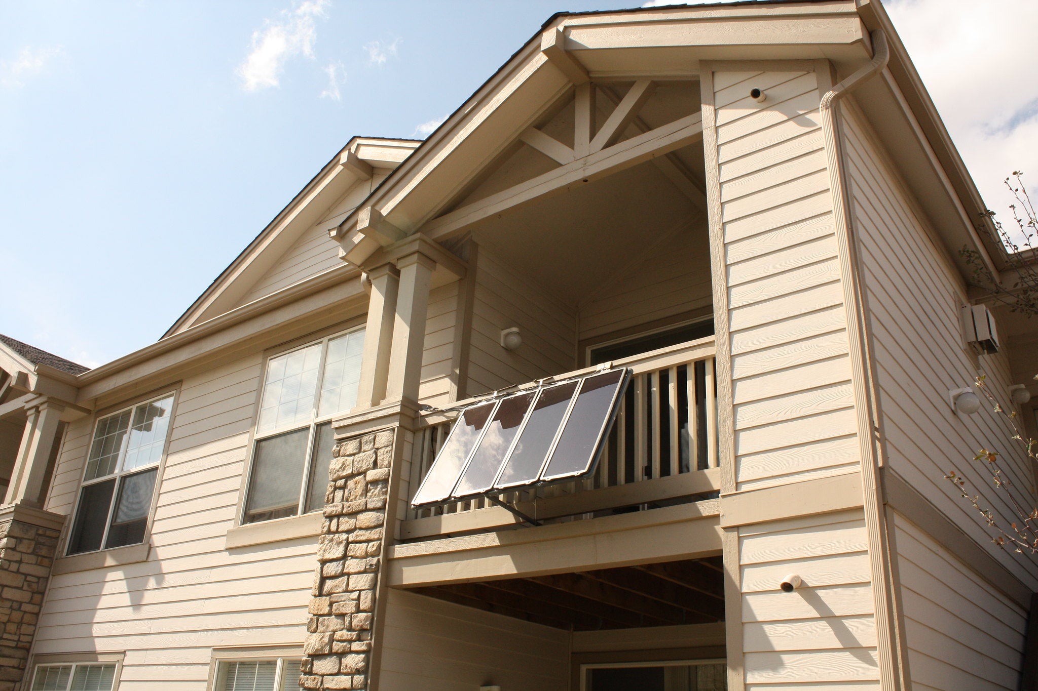 Solar panels attached to balustrade on the balcony of a rental home