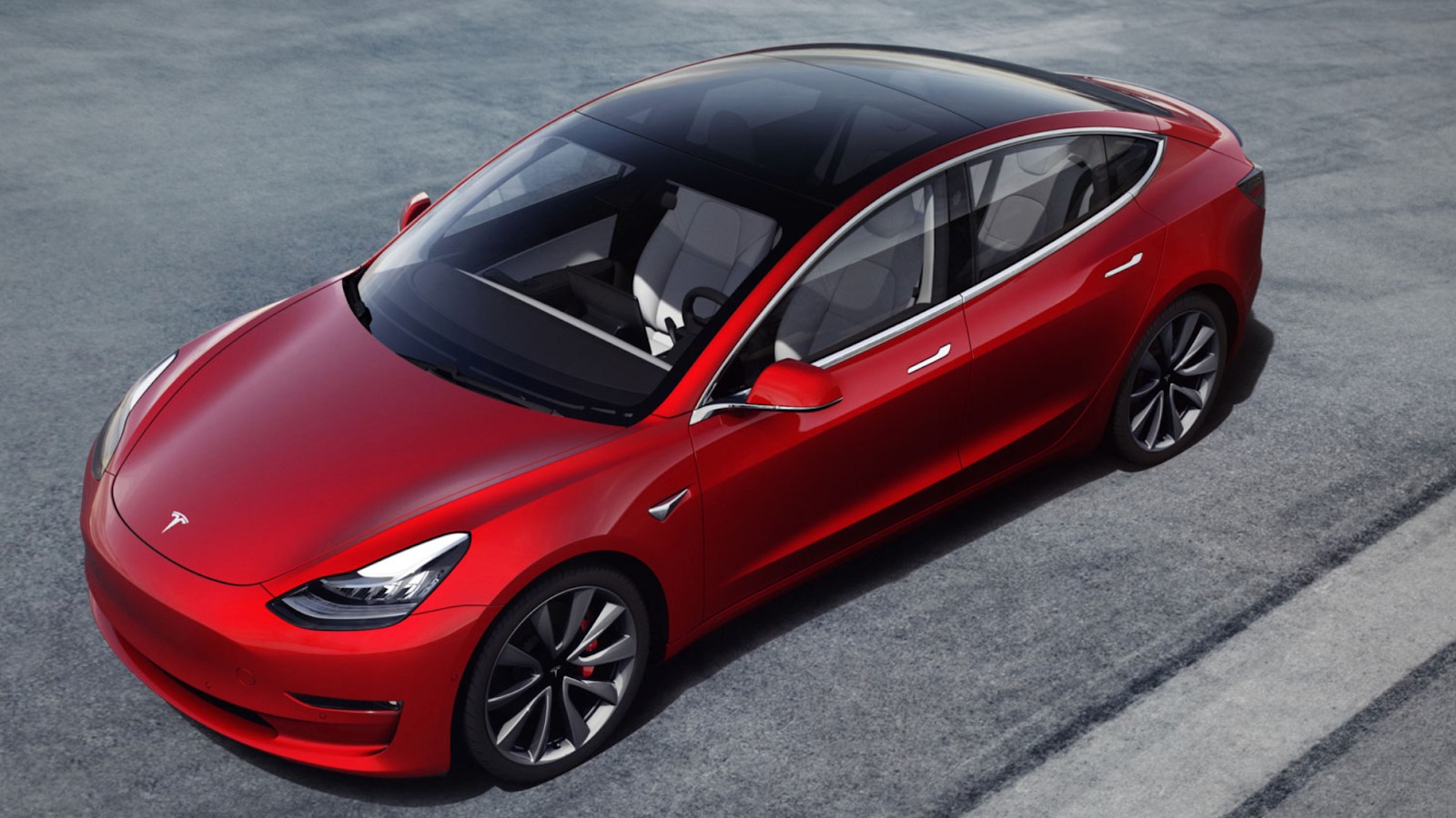 3/4 top view of a red Tesla model 3 with a sunroof