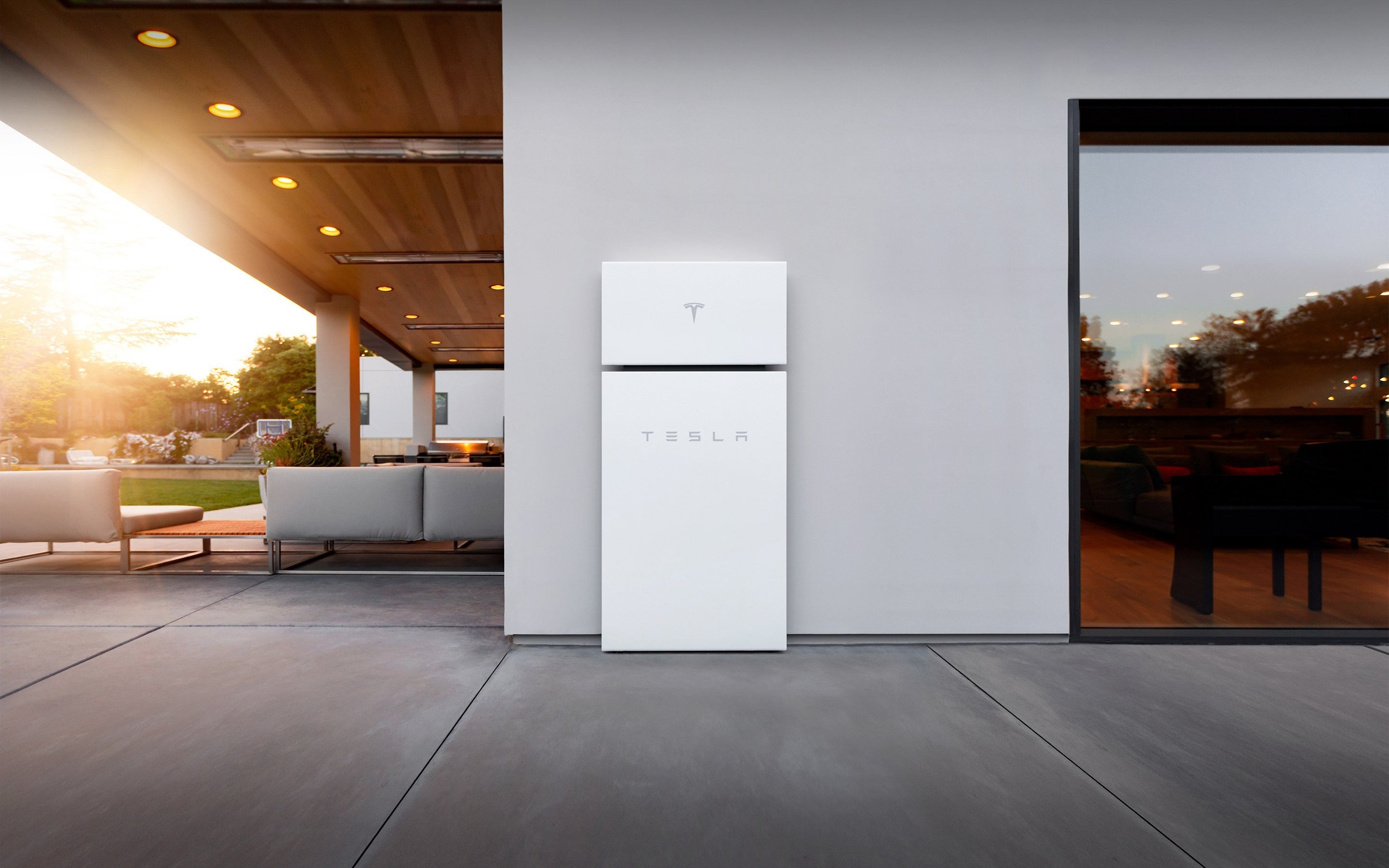 Photo of a Tesla Powerwall battery on an exterior wall